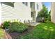 Backyard with a small stone patio, chairs, greenery and plants at 1201 Somers Dr, Morrisville, NC 27560