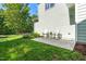 Backyard patio with chairs and a view of the grass and green leafy trees at 1201 Somers Dr, Morrisville, NC 27560