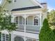 Close up of the charming balcony with intricate white railings and peaceful view of the landscaping at 1201 Somers Dr, Morrisville, NC 27560