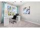 Bright bedroom with a white desk, black chair, light blue curtains, and a large window with outside view at 1201 Somers Dr, Morrisville, NC 27560