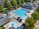 Aerial view of a community pool and recreational area with lounge chairs and umbrellas at 1201 Somers Dr, Morrisville, NC 27560