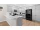 Modern kitchen featuring stainless steel appliances, gray cabinets, and a large island at 1201 Somers Dr, Morrisville, NC 27560