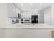 Contemporary kitchen with gray cabinetry, island with white countertop, and modern appliances at 1201 Somers Dr, Morrisville, NC 27560