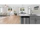 Open kitchen view to dining and living room areas with stainless steel appliances at 1201 Somers Dr, Morrisville, NC 27560