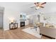 Inviting living room with a cozy fireplace, ceiling fan, and wood-look flooring at 1201 Somers Dr, Morrisville, NC 27560