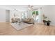 Sun-filled living room with plush rug, ceiling fans, and large windows with natural light at 1201 Somers Dr, Morrisville, NC 27560