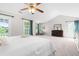 Large, bright primary bedroom boasts high ceilings, ensuite access, and windows with wooded views at 1201 Somers Dr, Morrisville, NC 27560