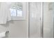 Modern, glass shower features bright lighting and an ornate, patterned window with white curtains at 1201 Somers Dr, Morrisville, NC 27560