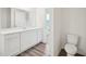 Contemporary bathroom showcasing wood-look floors and a white vanity at 1212 Solace Way, Rolesville, NC 27571