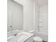 Clean, bright bathroom with modern vanity, white tile shower and tub, and tile flooring at 1212 Solace Way, Rolesville, NC 27571