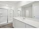 Bright bathroom with a quartz countertop vanity and a spacious glass shower at 1212 Solace Way, Rolesville, NC 27571