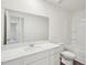 Clean, well-lit bathroom with white vanity, expansive mirror, and a shower-tub combination at 1212 Solace Way, Rolesville, NC 27571