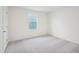 Bright, carpeted bedroom with a large window letting in ample natural light at 1212 Solace Way, Rolesville, NC 27571