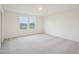 Inviting bedroom featuring neutral walls, plush carpeting, and a bright double window at 1212 Solace Way, Rolesville, NC 27571