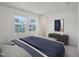 Sunlit bedroom featuring large windows with pleasant views of surrounding houses and trees at 1212 Solace Way, Rolesville, NC 27571