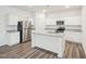 Beautiful kitchen with stainless steel refrigerator and center island with double sink and granite countertops at 1212 Solace Way, Rolesville, NC 27571