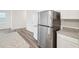 Contemporary kitchen with stainless steel refrigerator, granite countertops, and light wood-look flooring at 1212 Solace Way, Rolesville, NC 27571