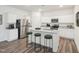 Modern kitchen features stainless steel appliances, granite countertops, and a kitchen island with barstool seating at 1212 Solace Way, Rolesville, NC 27571