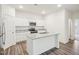 Bright kitchen features a center island with double sinks, granite countertops, and stainless steel microwave at 1212 Solace Way, Rolesville, NC 27571