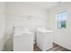 Practical laundry area with modern machines and a window providing natural light at 1212 Solace Way, Rolesville, NC 27571