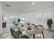 Well-lit living room with contemporary furniture and decor, seamlessly blending the dining and seating areas at 1212 Solace Way, Rolesville, NC 27571