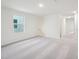 Bright living room featuring neutral walls, plush carpeting, and a large window at 1212 Solace Way, Rolesville, NC 27571