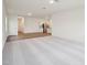 Open-concept living area featuring carpet, hardwood floors, and a seamless flow to a modern kitchen at 1212 Solace Way, Rolesville, NC 27571