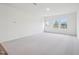 Spacious, carpeted living area with natural light and a back door, offering a seamless indoor-outdoor transition at 1212 Solace Way, Rolesville, NC 27571