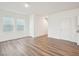 Bright open living space featuring hardwood floors, white walls and a hallway with staircase access at 1212 Solace Way, Rolesville, NC 27571
