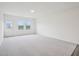 Bright, carpeted living space featuring natural light from large windows and access to the back yard at 1212 Solace Way, Rolesville, NC 27571