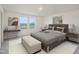 Luxurious main bedroom with a comfortable bed, stylish decor, and bright double windows at 1212 Solace Way, Rolesville, NC 27571