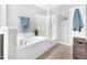 Bright bathroom with soaking tub, glass enclosed shower, and modern fixtures at 1312 Regulator St, Raleigh, NC 27603