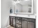 Bathroom featuring double sink vanity with dark cabinetry and decorative mirror at 1312 Regulator St, Raleigh, NC 27603