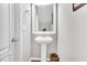 Powder room with a pedestal sink and classic decor at 1312 Regulator St, Raleigh, NC 27603