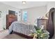 Cozy bedroom with a dresser, TV, and window for natural light at 1312 Regulator St, Raleigh, NC 27603