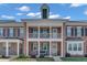 Charming brick townhome with a covered front porch and upper balcony at 1312 Regulator St, Raleigh, NC 27603