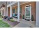 Welcoming front porch with charming bench, potted plants, and green door at 1312 Regulator St, Raleigh, NC 27603
