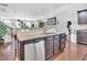 Open kitchen featuring dark cabinetry and tile backsplash at 1312 Regulator St, Raleigh, NC 27603