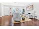 Bright living room with hardwood floors, a white couch, and large windows at 1312 Regulator St, Raleigh, NC 27603