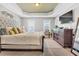 Spacious main bedroom with tray ceiling, large bed, dresser, and plenty of natural light at 1312 Regulator St, Raleigh, NC 27603