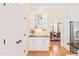 Charming bar area showcasing white cabinetry and a view to the nearby dining room and kitchen at 1317 Woodgate Manor Ct, Raleigh, NC 27614