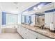 Well-appointed bathroom with double vanity, granite countertops, soaking tub, and walk-in shower at 1317 Woodgate Manor Ct, Raleigh, NC 27614