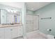Well-lit bathroom featuring a granite vanity and enclosed shower at 1317 Woodgate Manor Ct, Raleigh, NC 27614