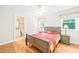 Well-lit bedroom with hardwood floors, ceiling fan, and ensuite bathroom at 1317 Woodgate Manor Ct, Raleigh, NC 27614