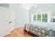 Inviting bedroom featuring natural light, hardwood floors, and vaulted ceiling at 1317 Woodgate Manor Ct, Raleigh, NC 27614
