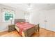 Bedroom with hardwood floors, bright window, ceiling fan, and a closet at 1317 Woodgate Manor Ct, Raleigh, NC 27614