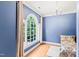 Cozy bedroom with a large window, hardwood floors, and a chandelier at 1317 Woodgate Manor Ct, Raleigh, NC 27614