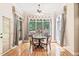 Inviting breakfast nook featuring large windows offering serene backyard views at 1317 Woodgate Manor Ct, Raleigh, NC 27614