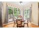 Cozy breakfast nook bathed in natural light, with views of the landscaped backyard at 1317 Woodgate Manor Ct, Raleigh, NC 27614