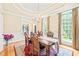 Elegant dining room features tray ceiling, grand chandelier, large windows, and classic wooden furniture at 1317 Woodgate Manor Ct, Raleigh, NC 27614